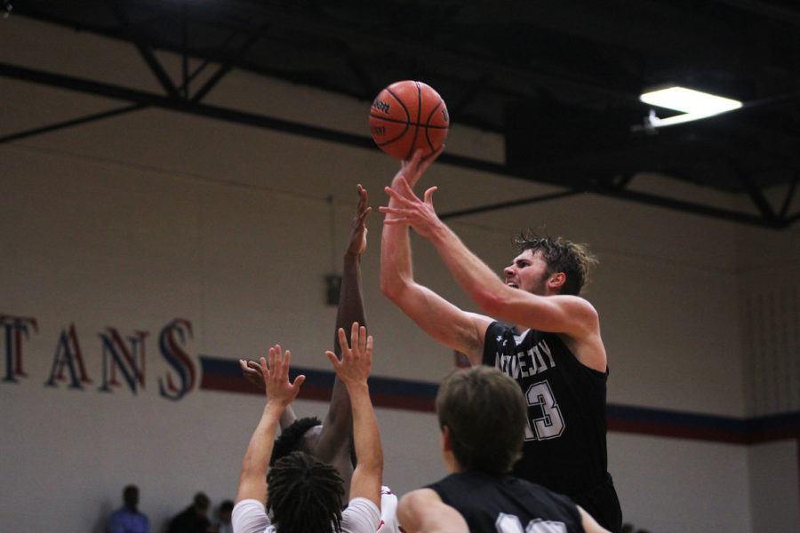 Senior Kyle Olson elevates over the defense in attempts to make a layup.