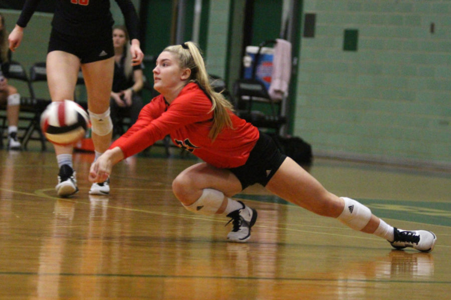 Senior Michelle Foster dives to defend a hit from an outside hitter.