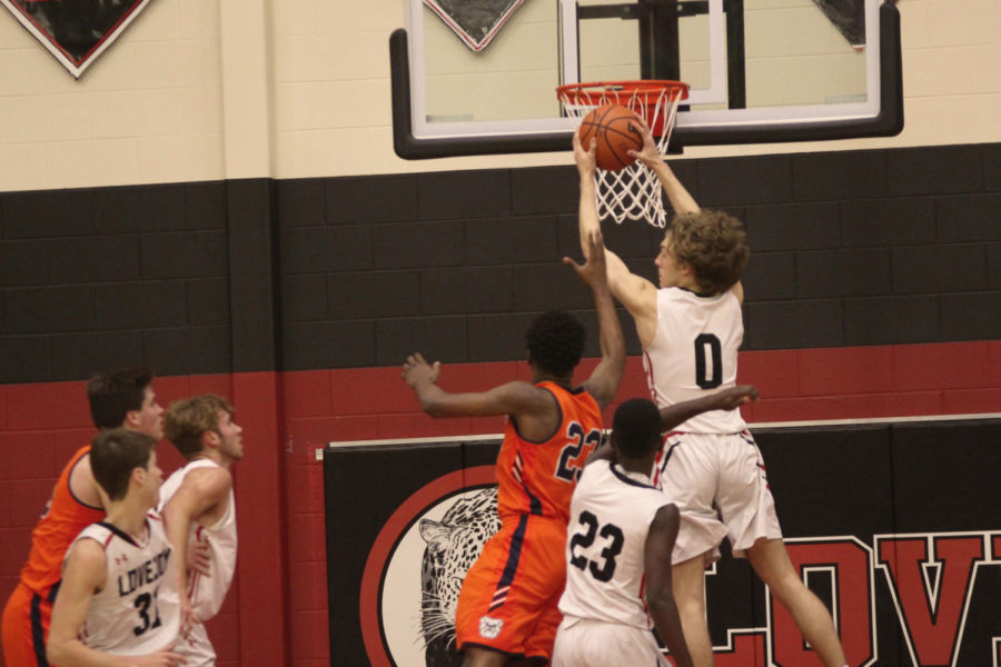 Junior guard, Kolby McSpadden, grabs a rebound off the glass after a missed shot from McKinney North.