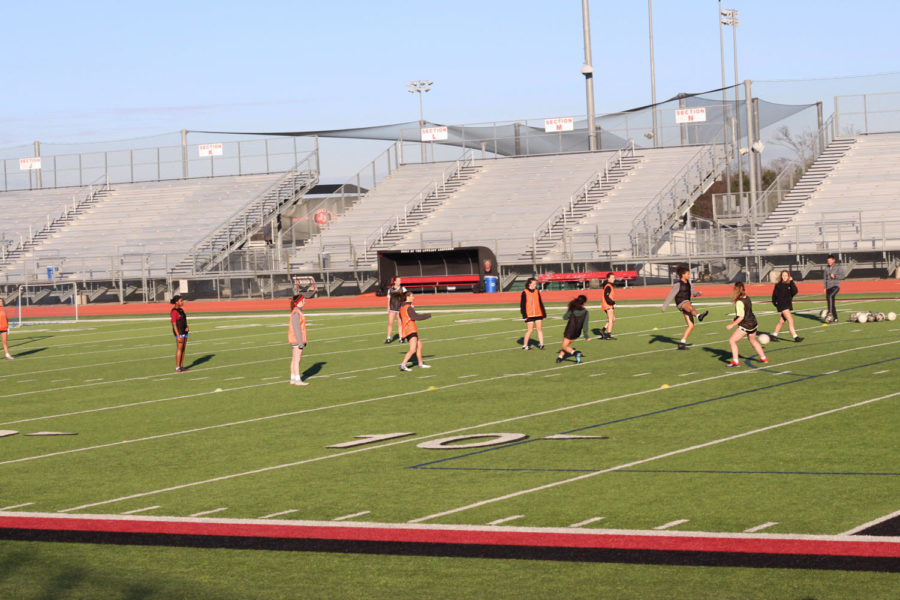 The girls soccer team runs drills.