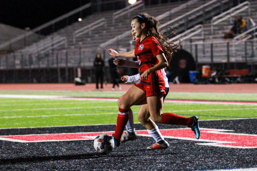 Senior Reagan Matacale maneuvers around a defender in the open field.