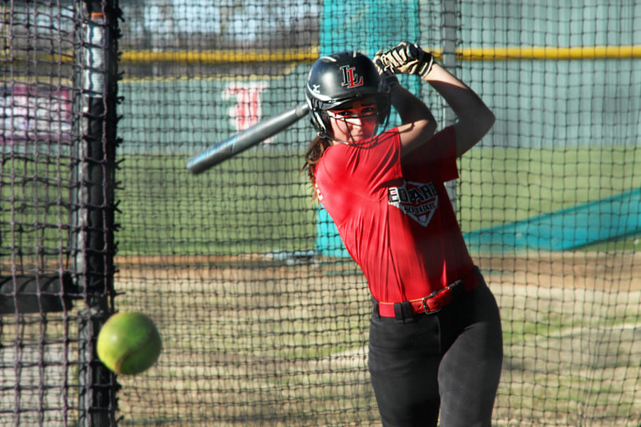 Junior Carlee Schaeffer takes a swing in the batting cage.