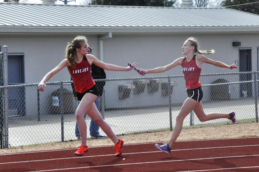 Freshmen Katie Armstrong and Lakin Hockersmith exchange the baton in the 4x200 m relay. 