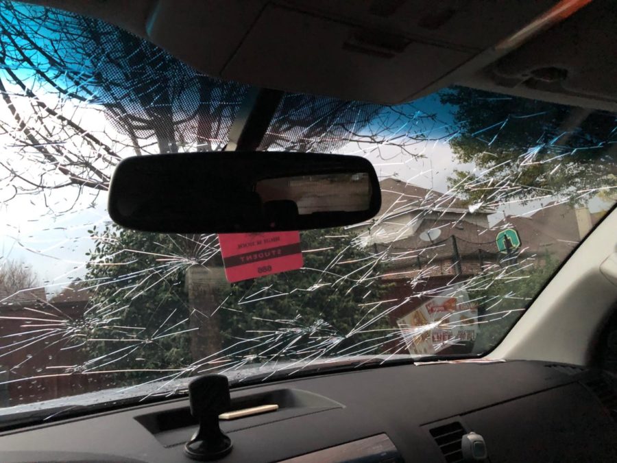 Junior Andrew Khalil waited in his car partially under a gas station roof during the March 24 severe hail storm. Hail dented his car and shattered the windshield.