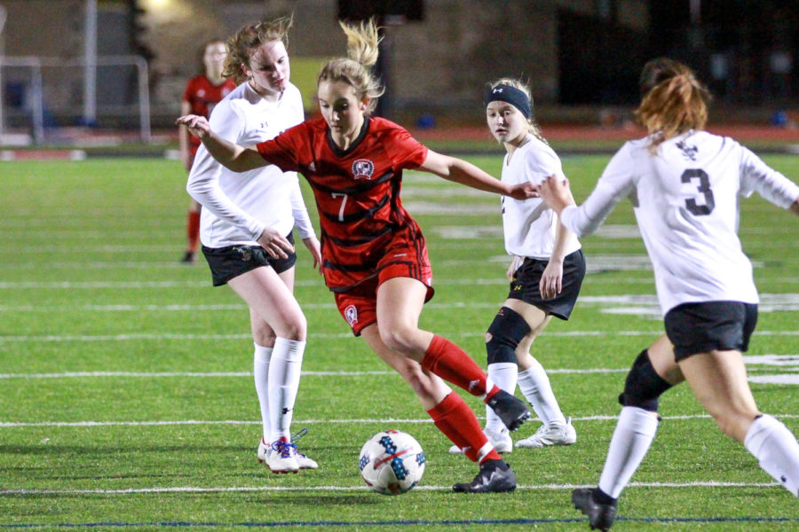 Freshman Tatum Chester picks the ball and looks towards the goal.