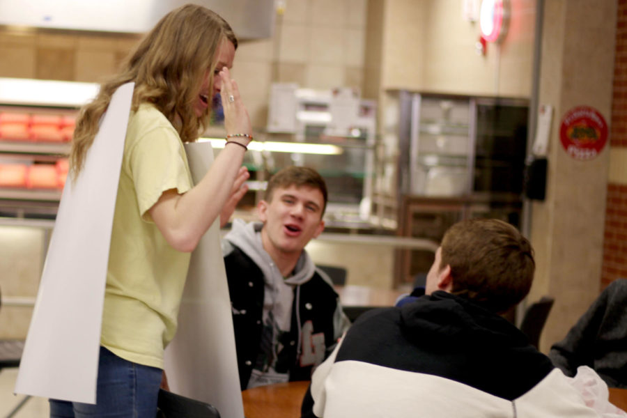 Senior Sarah Collins wears a free high-five sign to promote friendly interaction between students. 