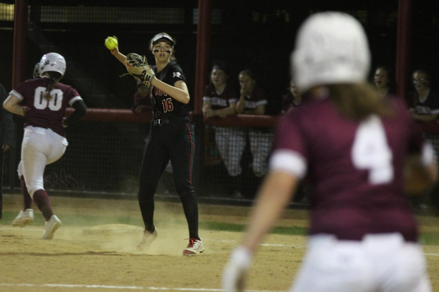 Senior Rebecca Holiman throws the ball back to the pitcher after getting it out at first. 