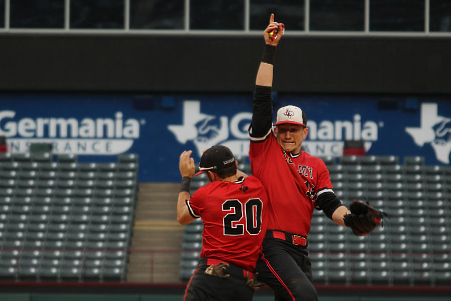 Sophomore Ralph Rucker and junior Logan Bowling celebrate their teams victory coming in from the outfield following the conclusion of the seventh inning. 
