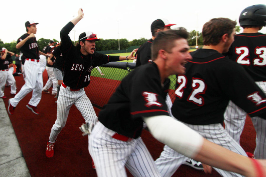 Junior Sam Coit and his teammates rush onto the field following a home run. 