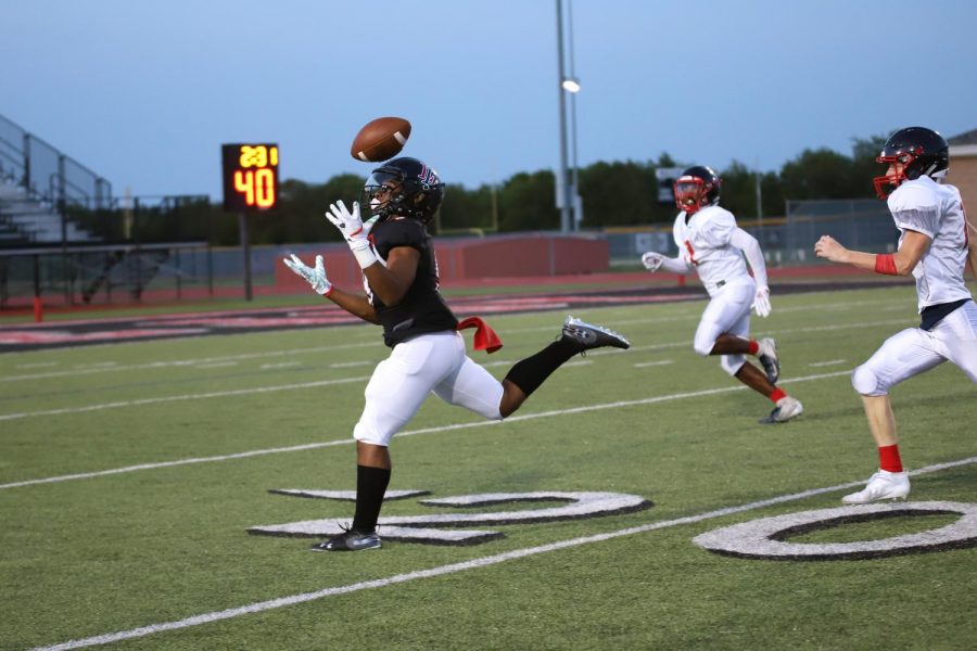 Sophomore Noah Naidoo receives a pass at the 20 yard line before reaching the goal line in last weeks scrimmage against Centennial. The scrimmage allowed the Leopards to face live competition before the Tom Landry Classic.