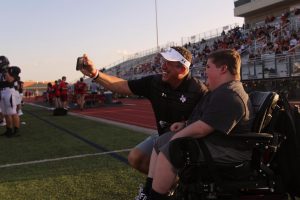 Superintendent Dr. Mike Goddard takes a selfie with sophomore Reid White on the sideline before the first play. This is Goddard's first year as superintendent, and his iconic selfies express his enthusiasm for the position.