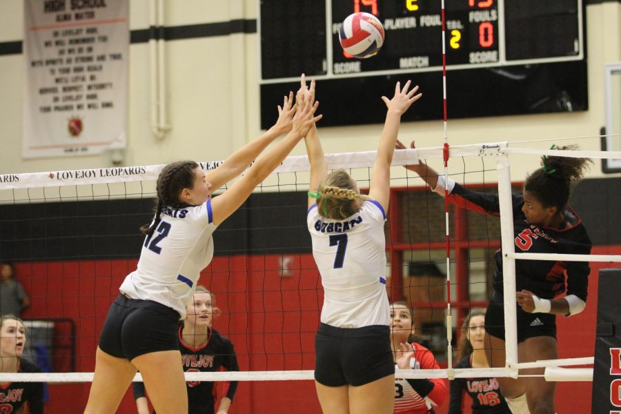 Junior Cecily Bramschreiber goes up for hit against Byron Nelsons Payton Chamberlain (12) and Nina Petersen (7). Bramschreiber hits the ball over defenders keeping the ball on the opponents side of the court.