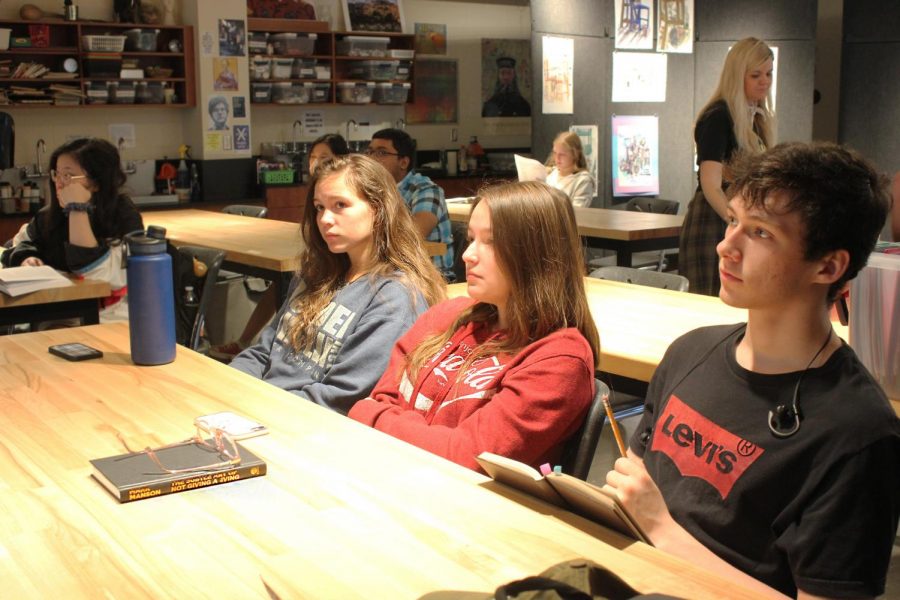 Junior Brynne Davies and seniors Marisa Medrano and William Floyd listen to Arianne Ohman present her slides at the Art History Club meeting Wednesday morning.