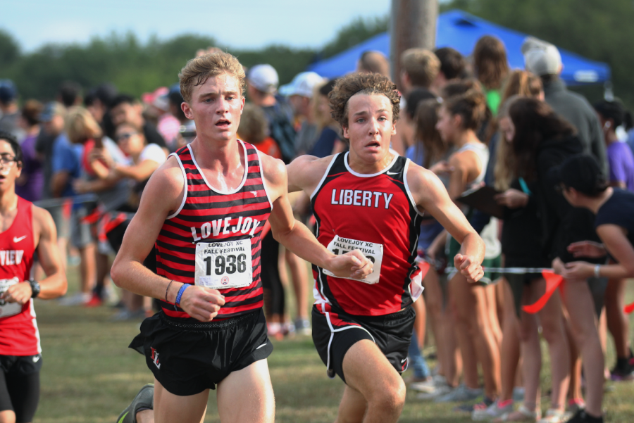 Frisco Liberty Sophomore Chris Coppinger trails Senior Sam Rouse in the Division 1 Varsity boys race. Coppinger ended up beating Rouse by .03 seconds.