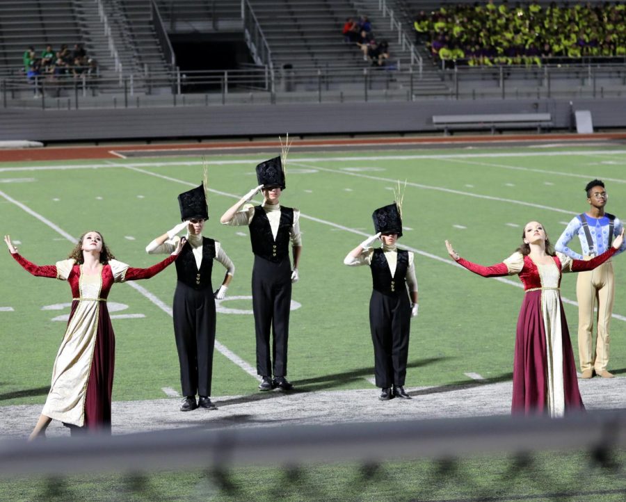 The drum majors, senior Lily Hager, senior Joe Harris and junior Catherine OBrien, salute during drum major retreat where they receive the awards for the band. Also shown are Guard Captain junior Elise Bell and Lieutenant junior Jordan Sleeper. This season, the band won two marching invitational competitions.