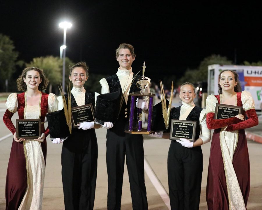 Guard Captain and junior Elise Bell, Drum Majors senior Lily Hager, senior Joe Harris, junior Catherine OBrien, and Guard Lieutenant Jordan Sleeper smile outside the Golden Gate Triangle stadium after receiving the award for the first first place in the schools marching band history. The band also won the captions for colorguard, woodwinds, music general effect, and visual individual performance on that day, Sept. 28.