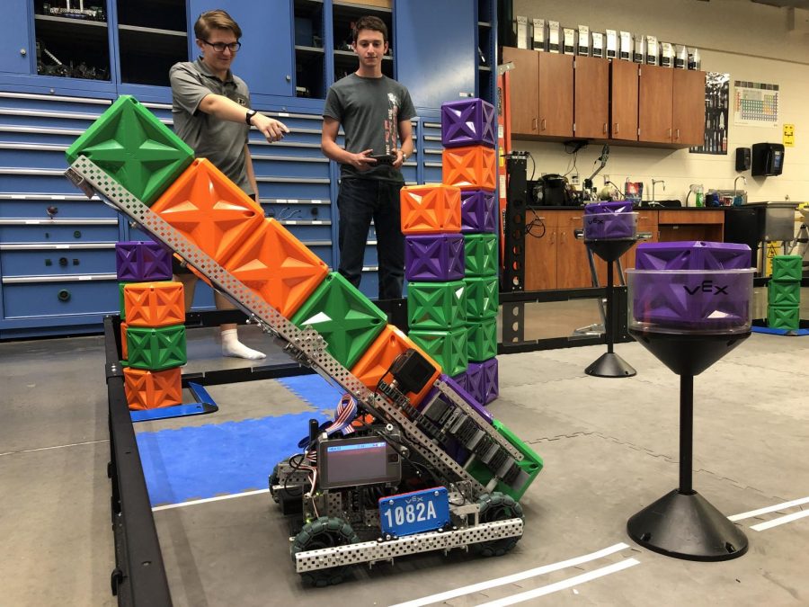 Senior Anthony Ciletti and senior Jake Bluestein practice for the competition by having the robot pick up cubes.