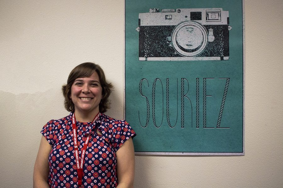 French teacher Billie Kelsey stands in front of a poster in her room that says “smile” in French, as it’s one of her favorite classroom decorations as a new teacher.