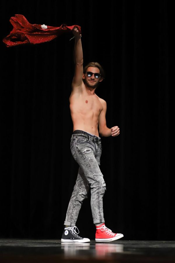 Senior Christian Cortez takes off his shirt and waves it around as he is introduced as a Mr. Lovejoy contestant.