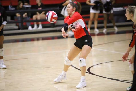 Senior Emma Johnson defends the ball from Sherman's outside hitter. The Leopards won their second set 25-12.