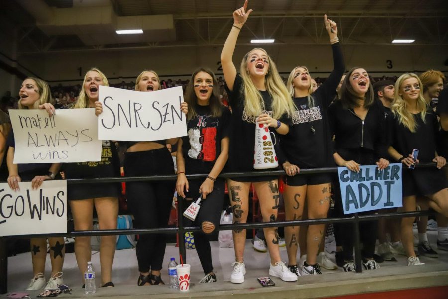 The senior student section expresses their support during the game. Students created signs and painted faces before the game earlier that day. 