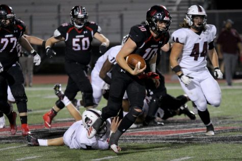 Junior quarterback Ralph Rucker (10) scampers across midfield after escaping the passer's pocket. Rucker leads the Leopards this season in both passing and rushing yards.
