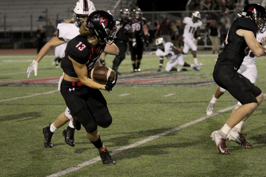 Junior Luke Mayfield runs the ball past the 45-yard-line to pick up a Lovejoy first down.