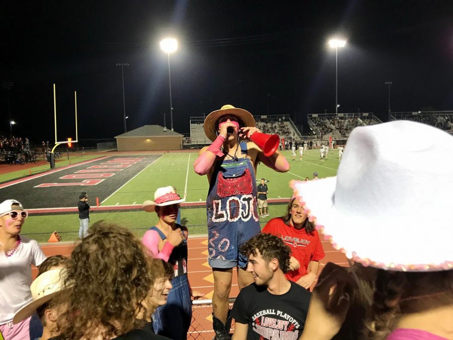 Senior Matt Piccirillo leads on Lovejoys student section, the Jungle, at the game. Matt Piccirillo is a member of the Dirty Drumline.