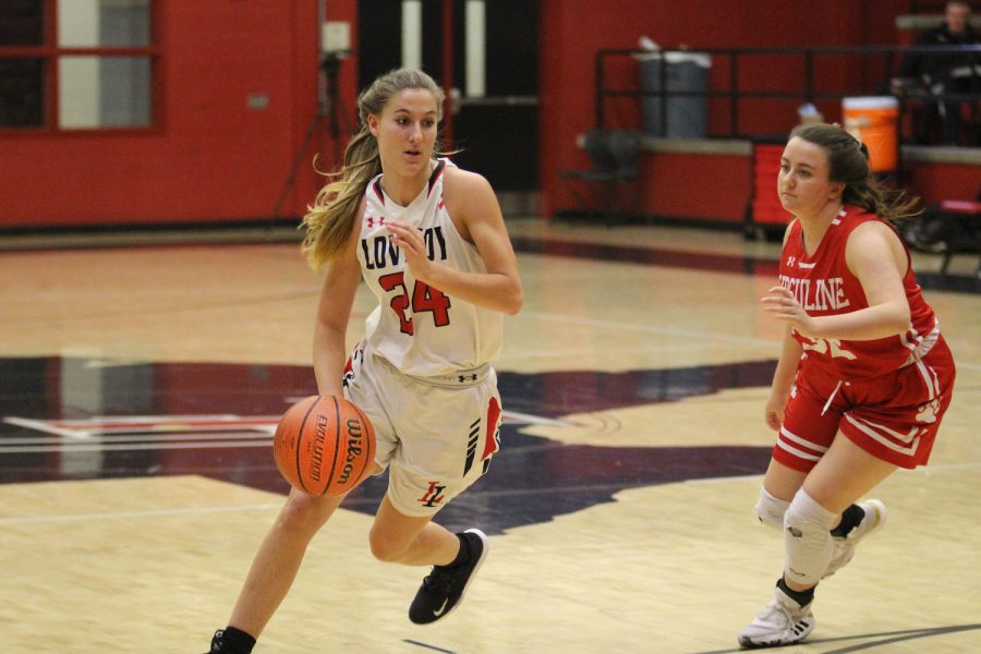 Senior Carsen McFadden dribbles the ball around one of Ursuline’s players. The Leopards won the game by one point.
