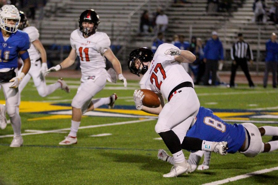 Senior Will Hannah carries the ball towards the 50-yard-line. Hannah avoids a tackle from one of Friscos defensive players.