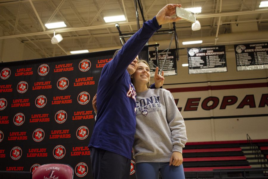 Senior Ana Laura Faoro takes a selfie with a family member following the signing.