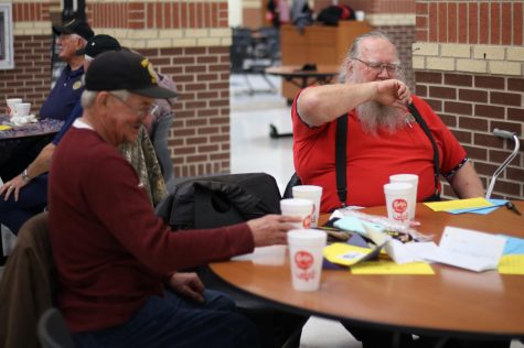 Don lange (right) shares their story and finds common ground about his experiences with a fellow veteran. Later during the Veterans Day Dinner on Monday Dr. Mike Goddard, the Lovejoy Superintendent, asks the veterans about their experiences in the military. 