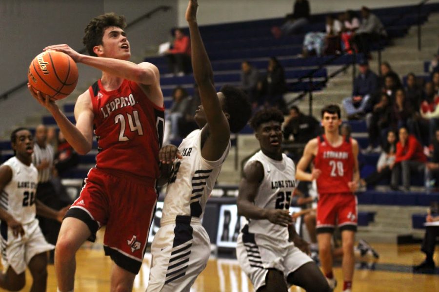 Junior Carson Holden goes up for a shot while being guarded by Lonestars Javion Tate. 