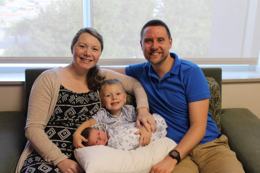 Annastacia and Tim Daugherty pose with their sons Owen and Kian in the hospital following Kians birth. Tim took a week off while Annastacia took eight before returning.  