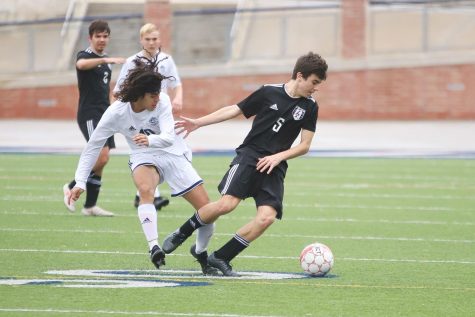 Sophomore Michael Beaney takes posession of the ball during the first quarter of the game against Flower Mound.