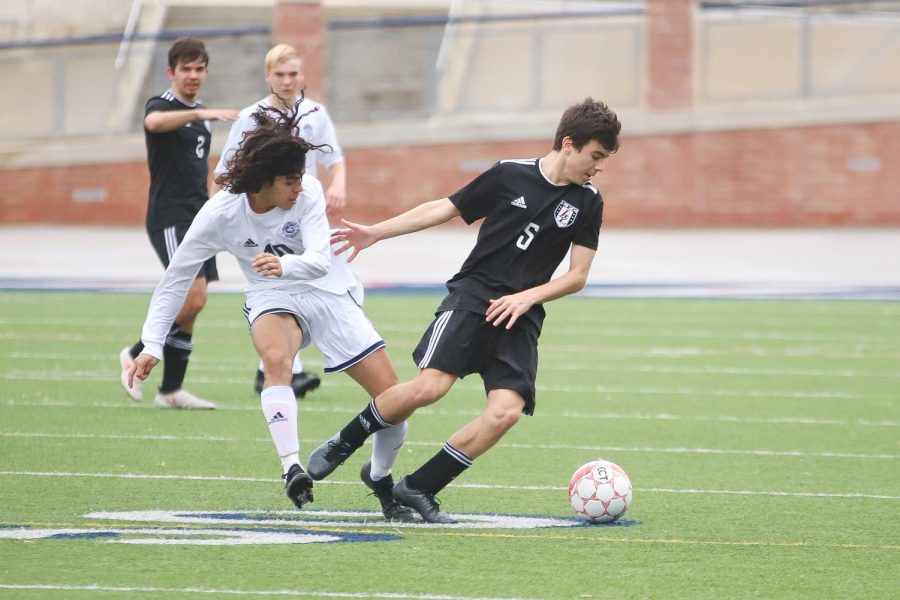 Sophomore Michael Beaney takes posession of the ball during the first quarter of the game against Flower Mound. 