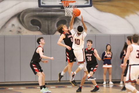 Senior Kolby McSpadden blocks a shot by Mckinney North's Todd Jones.