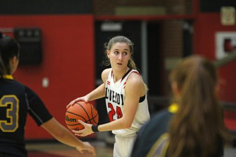 Senior Carsen McFadden looks to drive to the lane and dump the ball to senior Carly Ludlow for a basket.