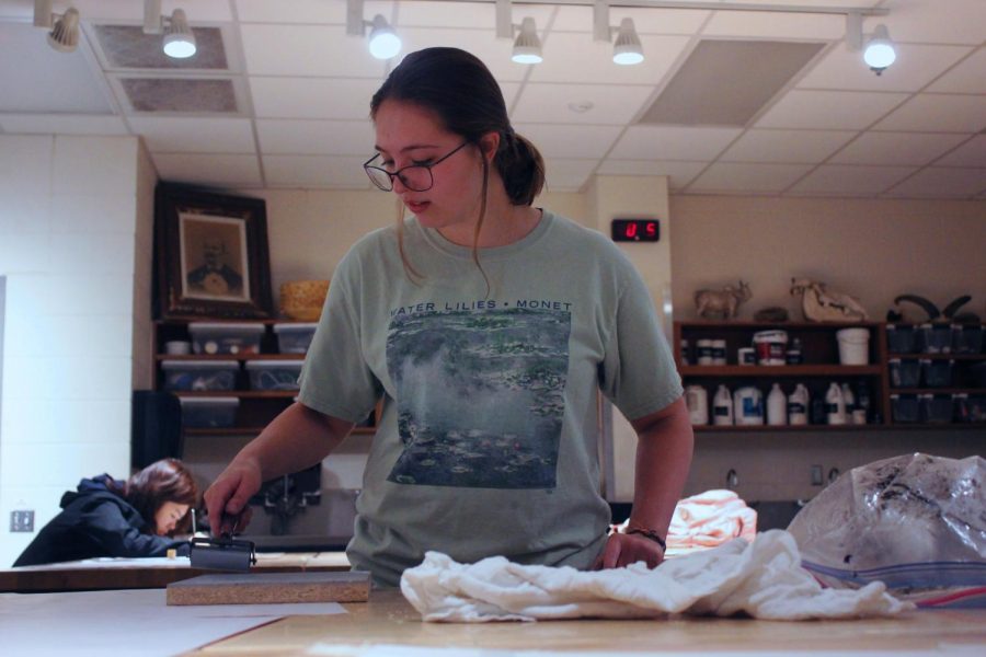 Junior Kiley Boots, does printmaking early in the morning for her portfolio. It is her second project this semester.