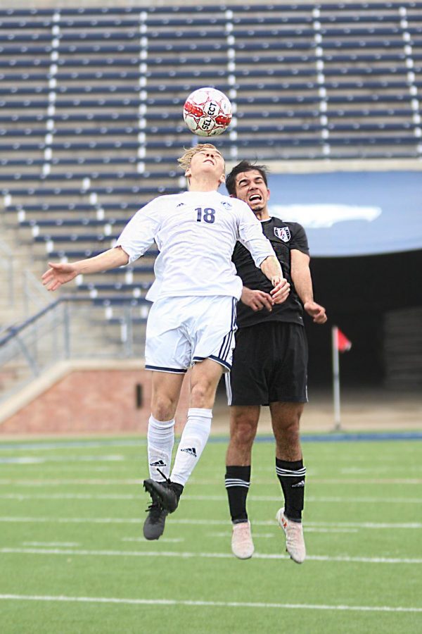 Senior Michael Branch heads the ball during the second half.