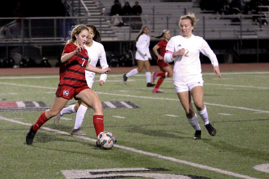 Sophomore Tatum Chester dribbles around two of The Colonys midfielders. This is the Lady Leopards first pre-district game.