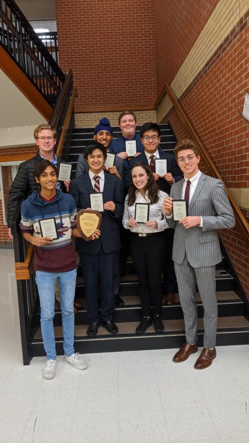 The National Speech and Debate Qualifiers pose with their respective awards following a tournament. 