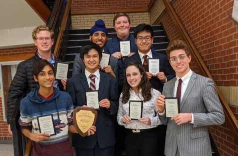 The National Speech and Debate Qualifiers pose with their respective awards following a tournament. 