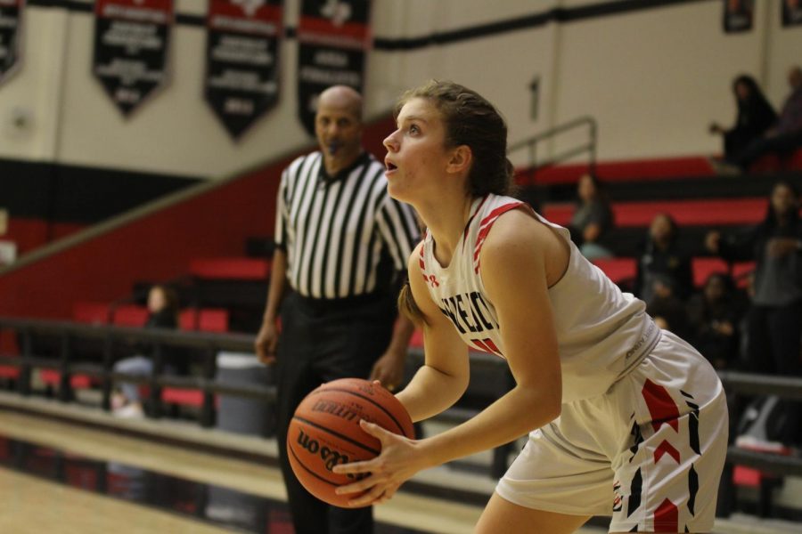 Junior Julia Brochu looks to shoot a three pointer against Denison.