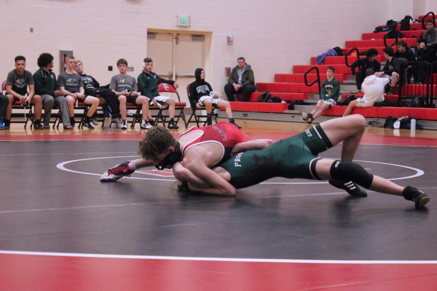 Sophomore Zach Darrow wrestles his opponent during his match on Jan. 28. Last Thursday, the wrestling achieved the schools first at a district competition. 