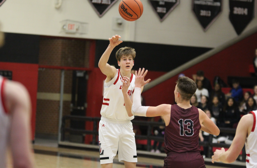 Senior Jared Langs passes the ball to senior Owen Abramson for the shot against Princeton.