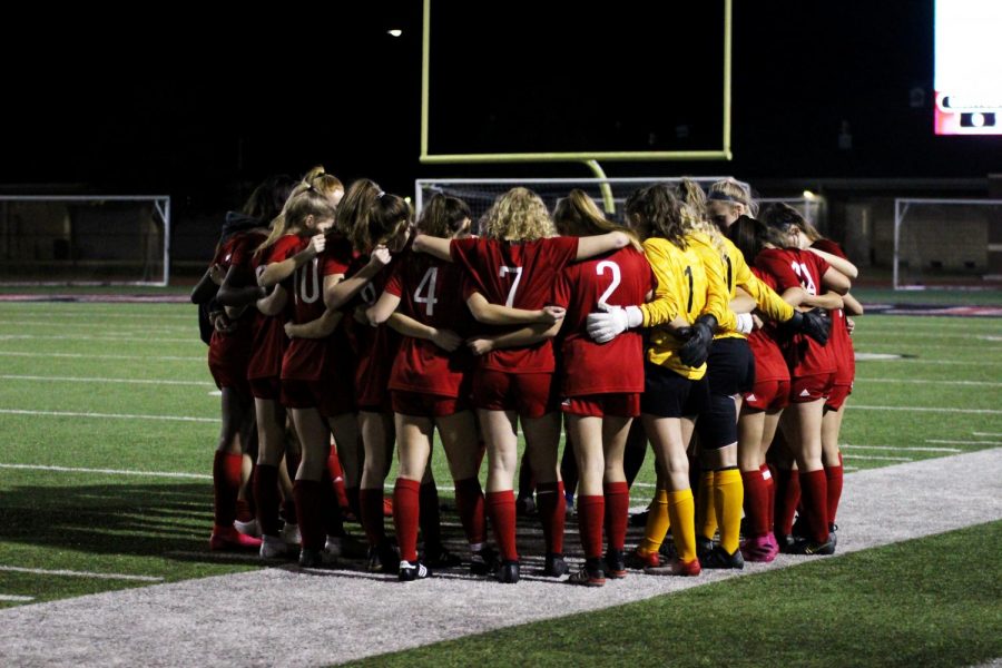 The Lady Leopards huddle before the game. The team takes a moment to take about game tactics before every game. 