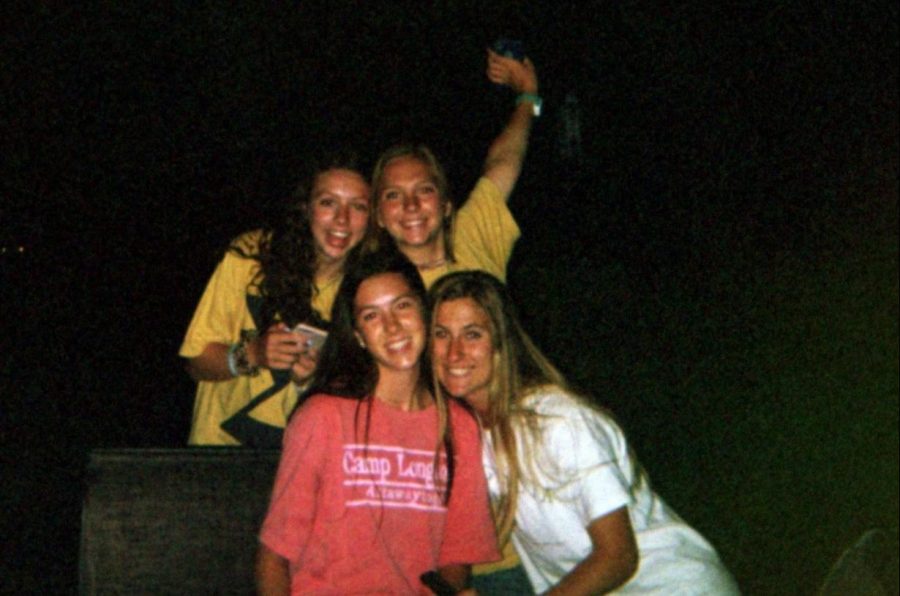 Seniors Olivia Porsch, Madeline Sanders, Lily McCutcheon and Carsen McFadden gather around a bonfire in June after returning from camp.
