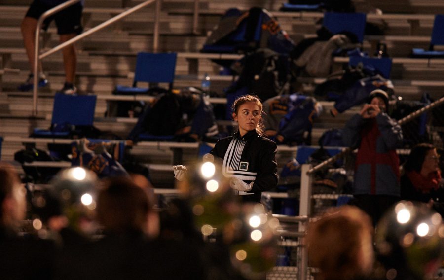 Lily Hager conducts the band during a pregame Friday night performance. This year concluded her seven-year band experience, as next year she will study Journalism at Texas A&M.