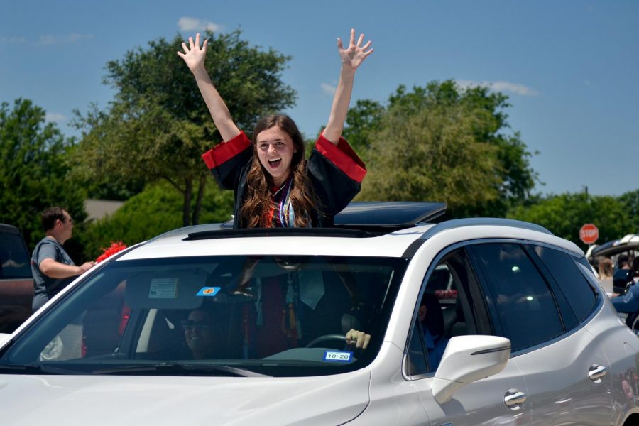 Graduate Lily Hager celebrates as the high school faculty cheers on the graduates. Hager will be attending the Texas A&M in the fall to study journalism. 